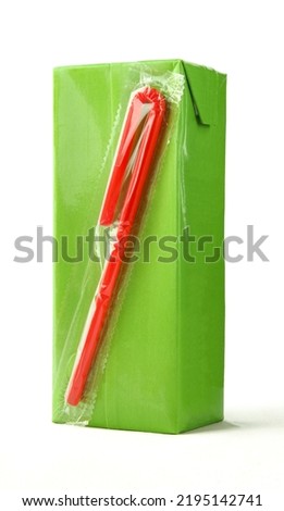 Green carton juice box with red plastic straw attached isolated on white background Royalty-Free Stock Photo #2195142741