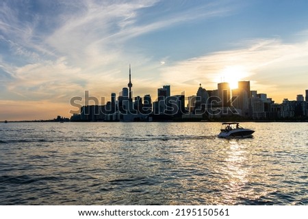 Toronto skyscraper skyline sunset panorama. Lake Ontario, Canada.