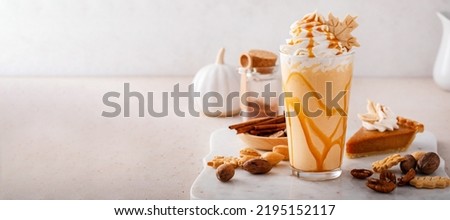 Pumpkin pie milkshake with caramel syrup and whipped cream on top Royalty-Free Stock Photo #2195152117