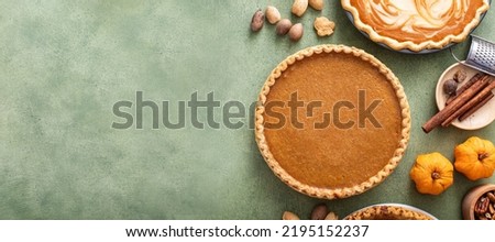 Traditional Thanksgiving pumpkin pie with flaky crust overhead view