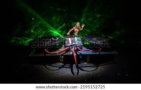 Happy Halloween horror party concept. Scary view of dancing zombies at cemetery with Dj and club lights. Creative artwork decoration. Useful as a party poster or greeting card. Selective focus
