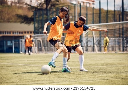 Young athletic women having soccer training at the stadium. Royalty-Free Stock Photo #2195154725