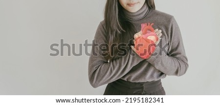woman clutching chest with heart anatomy, heart attack, heart disease, health concept Royalty-Free Stock Photo #2195182341