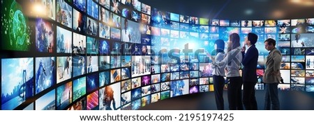 Multinational people watching videos. Video library. Wide image for banners, advertisements.