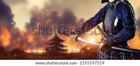 A samurai standing on the battlefield. Sengoku period. Wide image for banners, advertisements. Royalty-Free Stock Photo #2195197519