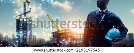 An engineer standing at a construction site and a digital data concept. Wide image for banners, advertisements.
