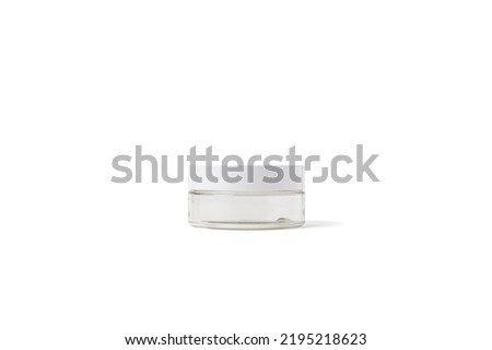 A plastic cosmetic container with a flat cylindrical shape, a white lid and a transparent body (with pass data) Royalty-Free Stock Photo #2195218623