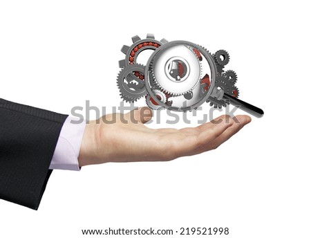 gears with gears and a magnifying glass over a businessman hand, operating analyzing concept