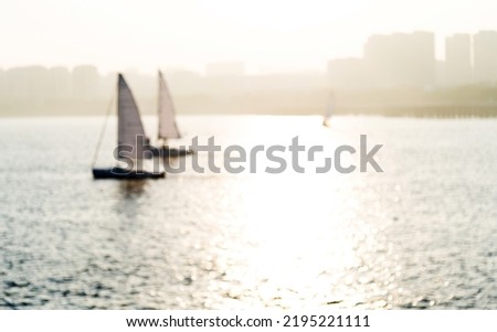 Sailboats in the sea at sunset.
