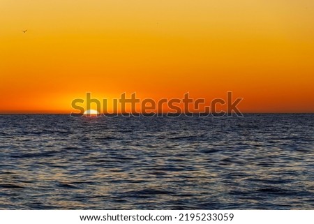 Amazing sunset on the Atlantic Ocean. The sun reflected in the waves. South Africa