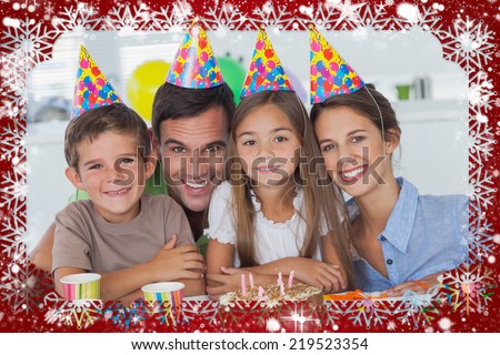 Composite image of beautiful family celebrating a party against snow