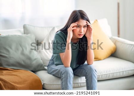 Sad tired young asian woman touching forehead having headache migraine or depression, upset frustrated girl troubled with problem feel stressed, Grief sorrow concept Royalty-Free Stock Photo #2195241091