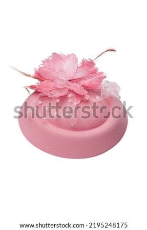 Close-up shot of a pink felt pillbox hat decorated with a flower, beads and feathers. The fascinator hat with an alligator clip is isolated on a white background. Front view. Royalty-Free Stock Photo #2195248175