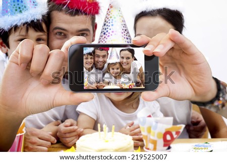 Composite image of hand holding smartphone showing photograph
