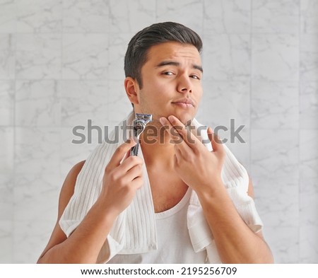 Man who wants to shave in front of the mirror, athlete and towel style, beard in the bathroom. Uzbekistan people. Royalty-Free Stock Photo #2195256709