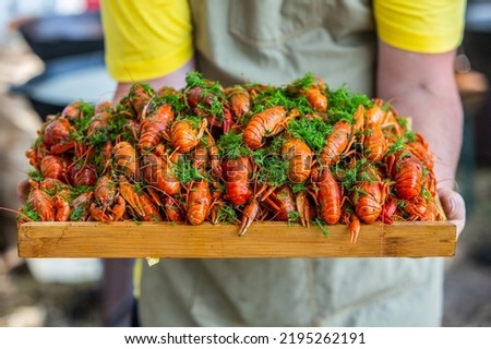 Boiled red crayfish or crawfish with herbs. Crayfish boiling in the pot on the fire. Royalty-Free Stock Photo #2195262191