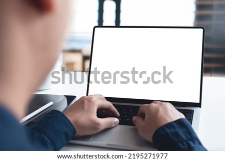 Mockup, blank screen laptop computer. Business man working on laptop computer on table at office. mock up for website design and digital marketing, over shoulder, rear view Royalty-Free Stock Photo #2195271977