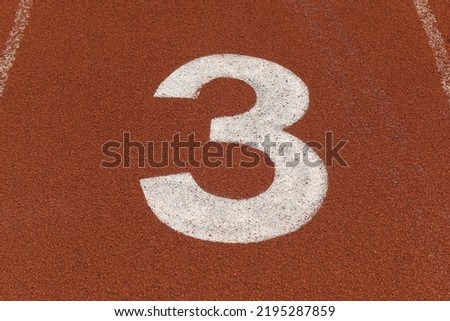 ์3 Number three white color on running track red field rubber floor 