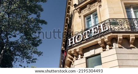 Hotel sign on building facade in city, travel and accommodation concept