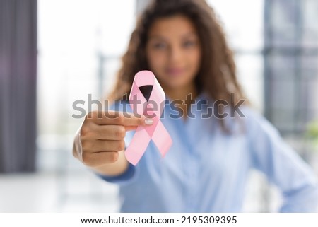 October breast cancer awareness month, woman with hand holding pink ribbon for supporting people living and illness. Healthcare, world cancer day concept Royalty-Free Stock Photo #2195309395