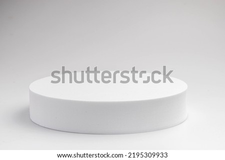 White product stand, mock up on a white background texture background Ideal backdrop for product presentations, exhibitions and mockups.