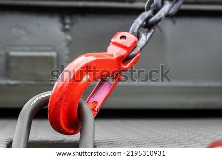 construction or military equipment is held by tension safety chains with hooks. Cargo transportation Royalty-Free Stock Photo #2195310931