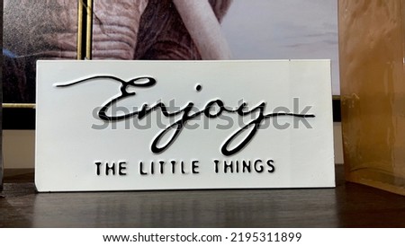 Enjoy the little things; motivational and inspirational quote words text engraved in a white wooden box