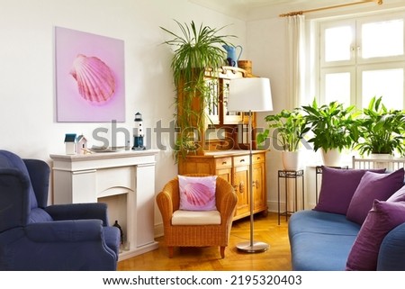 Custom-made home decoration concept: living room with a square canvas print of a pink shell picture and a throw pillow of the same photo.
