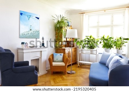 Custom-made home decoration concept: living room with a canvas print of a maritime holiday photo and a throw pillow of the same picture.