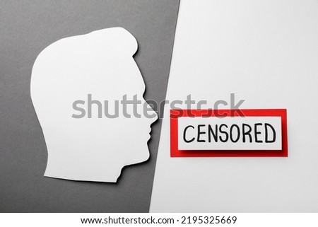 Card with word Censored and man's head cutout on color background, flat lay Royalty-Free Stock Photo #2195325669