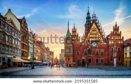 Wroclaw central market square with old houses and sunset. Panoramic evening view, long exposure, timelapse.  Historical capital of Silesia, Wroclaw (Breslau) , Poland, Europe. Royalty-Free Stock Photo #2195331585