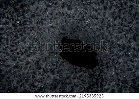 deep hole in the asphalt road. top view. Highway asphalt road background texture. landslide. Damaged asphalt road with pothole. bore in the asphalt pavement, earth with a recess.