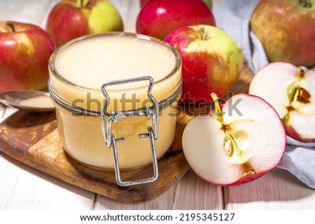 Homemade Organic Applesauce, healthy apple sauce in small jar with fresh summer apples on wooden white background Royalty-Free Stock Photo #2195345127