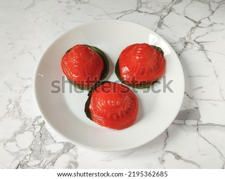 Kue Ku or Ang ku kueh, as known as Red tortoise cake, is a small round or oval-shaped Chinese pastry with soft, sticky glutinous rice flour skin wrapped around a sweet filling in the centre. Royalty-Free Stock Photo #2195362685