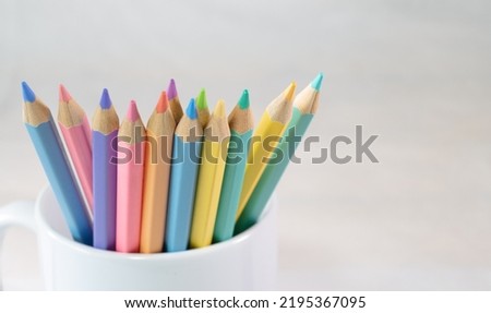 Color pencils in a white mug, Group of color pencils with white background, Copy space, Pastel color, Painting equipment, Drawing, Pastel colorful,  Education concept.
