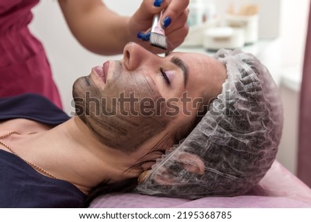 Portrait of a woman in a beauty salon for a carbon peeling procedure, close-up.