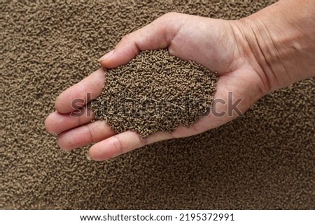 Animal feed mixed from finely ground protein powders of both plants and animals is pelleted to be used as pet food because pellets are convenient and accurate in feeding quantity.Copy Space background Royalty-Free Stock Photo #2195372991