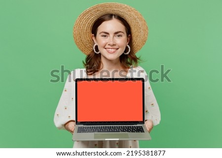 Young happy smiling fun freelancer fun woman she 20s wears white dress hat hold use work on laptop pc computer with blank screen workspace area isolated on plain pastel light green background studio
