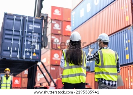 Caucasian business man and woman worker working in container terminal. Attractive engineer people processes orders and product at warehouse logistic in cargo freight ship for import export in harbor.
 Royalty-Free Stock Photo #2195385941