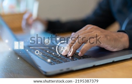 close up programmer man hand touch on laptop pad to select and launch API software programming to synchronize and transfer data from database to website for technology business concept