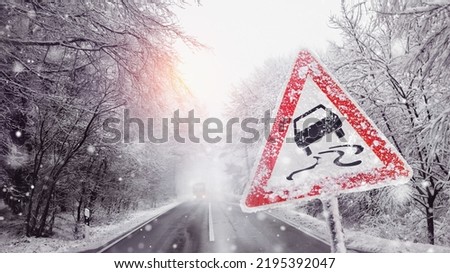 warning sign because of the black ice on the snowy road