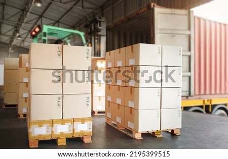 Packaging Boxes Stacked on Pallets Loading into Cargo Container. Shipping Trucks Transit. Supply Chain Shipment. Distribution Warehouse. Freight Trucks Cargo Transport. Supplies Warehouse Logistics. Royalty-Free Stock Photo #2195399515
