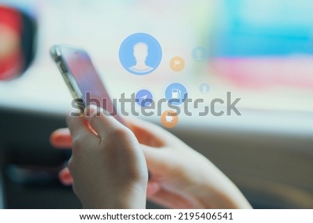 Blur, mobile phone, online communication, inside the car, during travel, close-up, with graphic icons displayed.