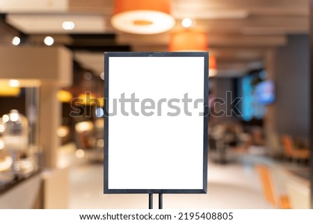 Mock up poster frame template in cafe table and seats interior advertising banner. Vertical empty advertising poster mock-up at the entrance of restaurant