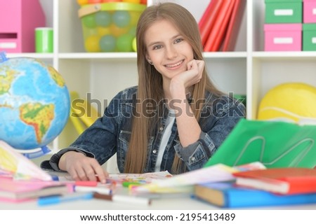 cute girl doing home work at desk