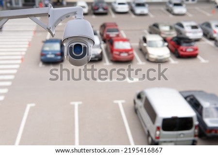 Technician installed IP CCTV camera hi-technology for look security area of work in car parking lot show signage with security cars park in area.