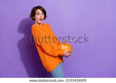 Profile side photo of young pretty woman impressed hold pumpkin isolated over violet color background