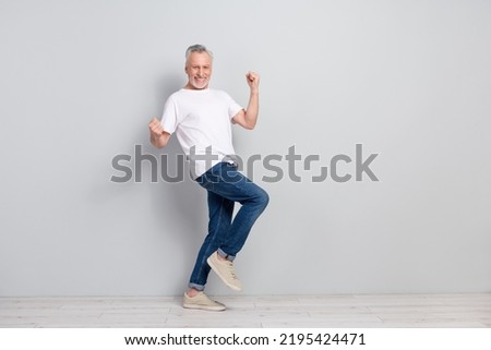 Full length body size view of attractive cheery lucky gray haired man rejoicing copy space isolated over concrete grey color wall background Royalty-Free Stock Photo #2195424471