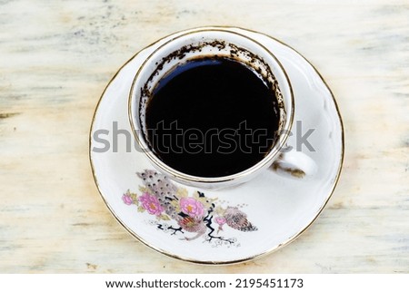 a cup black coffee on wooden