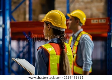 Warehouse workers and managers are also checking inventory stock in the warehouse. work in logistics Distribution Center. Working in logistics, Distribution center.. shot from behind